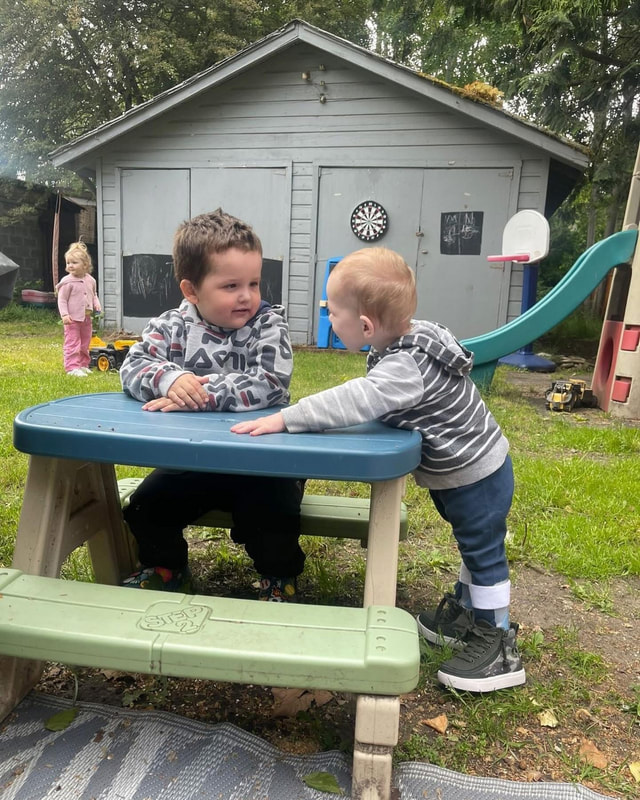 Children playing together at an outdoor picnic table